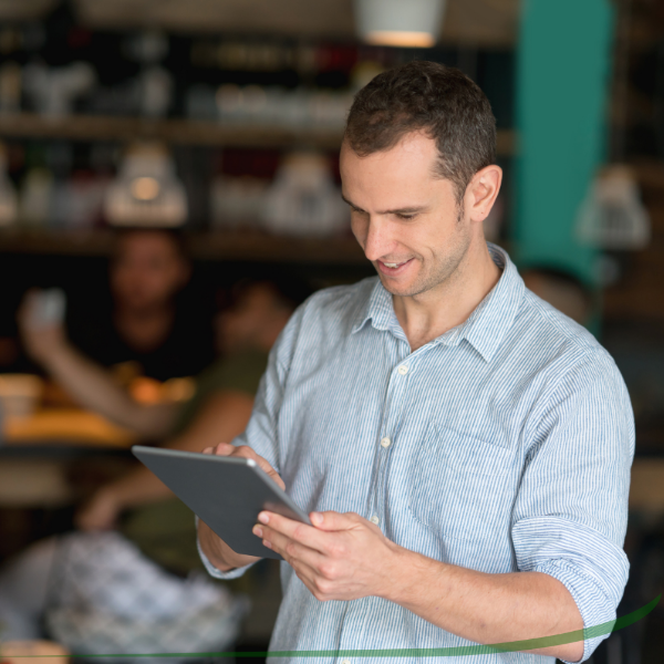 a man is looking into a tablet device