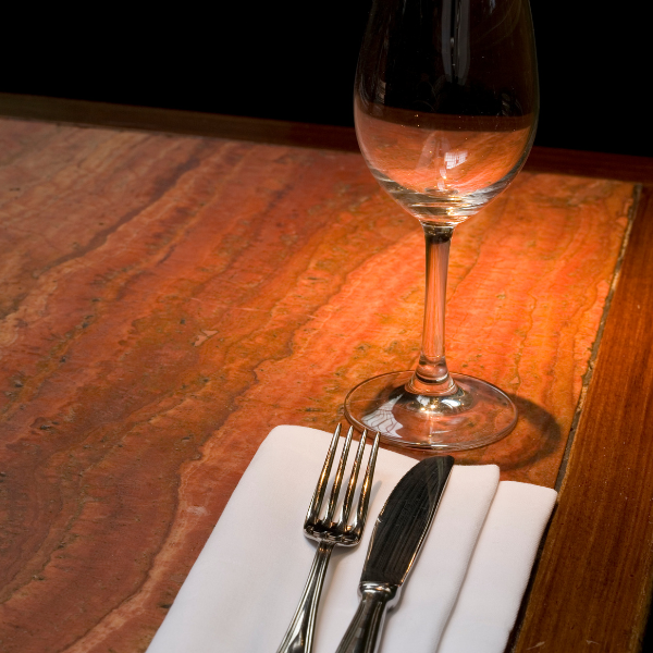 cutlery on white table napkin and wine glass