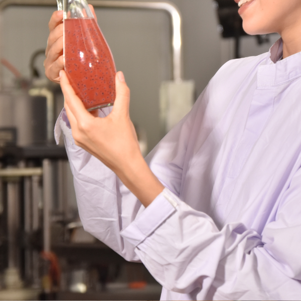 inspecting bottles with red edible beverage