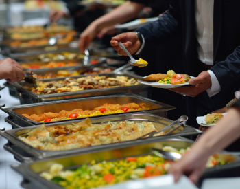 food on display at a buffet with visitors