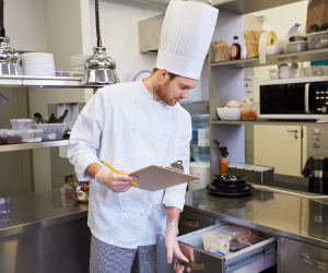 Man doing inventory check in kitchen