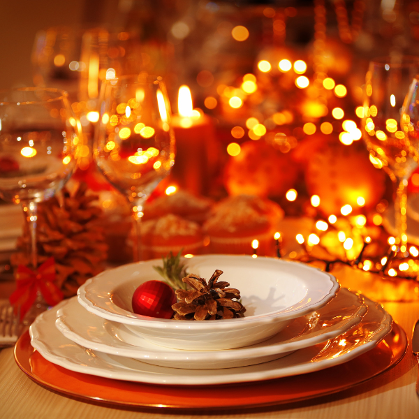 christmas dinner set up with plate, baubles, and lights