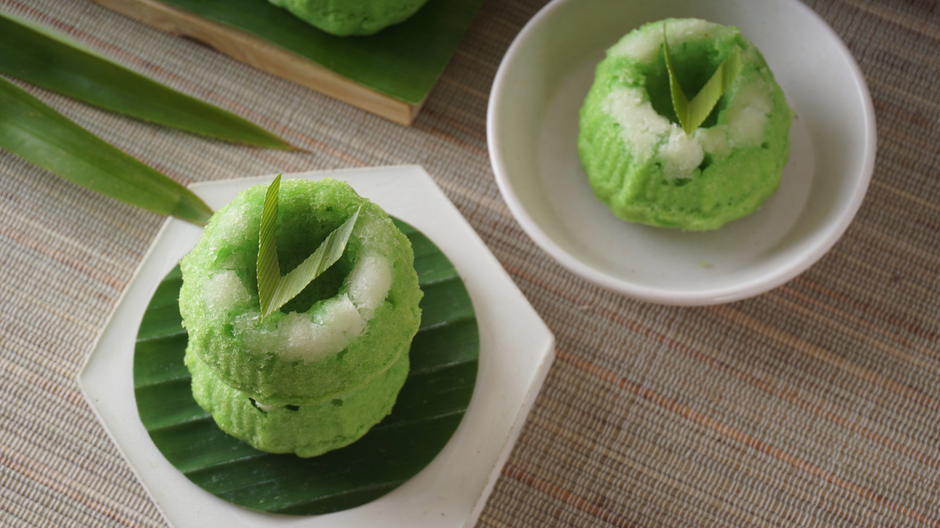 Disposable dessert plates on a wooden table with  colored green sweets