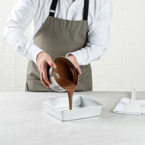 Man pouring chocolate to baking pan