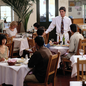 server with guests at restaurant