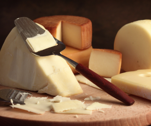 different cheeses with scraping tool