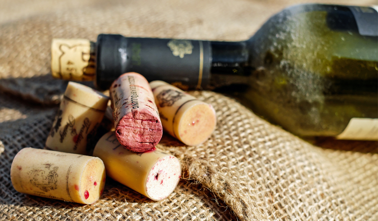 wine corks next to wine bottle