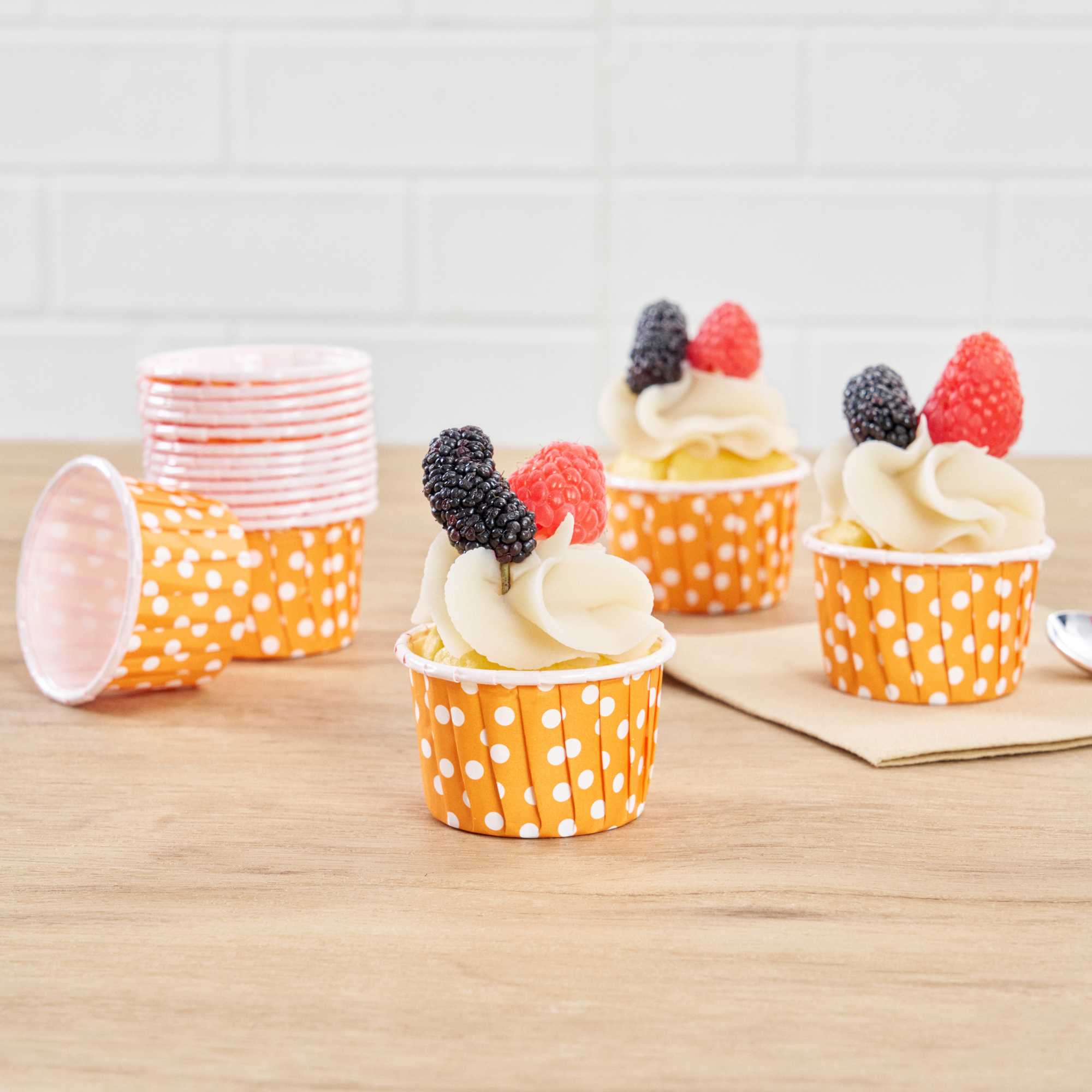 Panificio 2 oz Round Polka-Dotted Hot Orange Paper Medium Baking Cup - Pleated - 2 1/4" x 2 1/4" x 1 1/2" - 200 count box