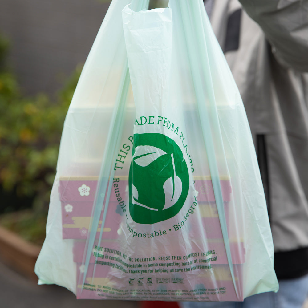 Basic Nature Green Plastic T-Shirt Bag - 1/6 Size, Compostable - 12" x 6 1/2" x 22" - 500 count box