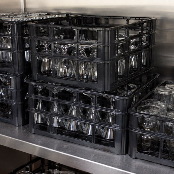 Racked bar glassware stored upside down on a shelf ready for service