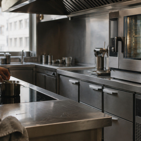 Chef cooking on a countertop induction cooker, one of the most energy-efficient kitchen appliances