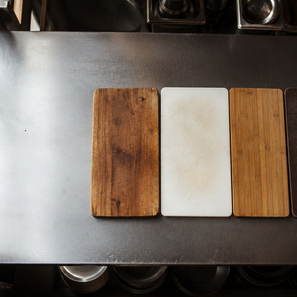 Comparison of wood, plastic, bamboo, and wood fiber cutting boards for commercial kitchens