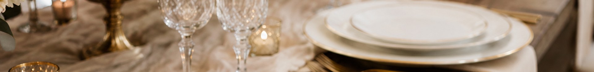 Elegant disposable wedding plates with gold rims on a styled reception table