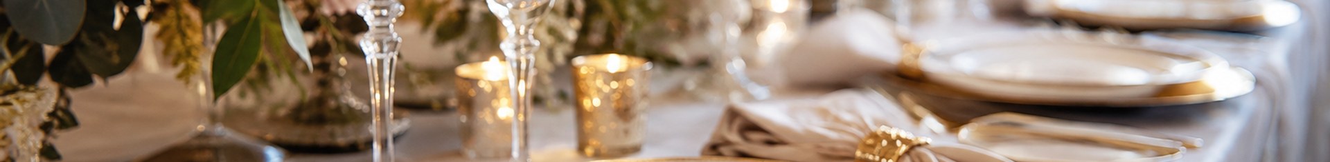 Fancy disposable plates with gold rims set on an upscale wedding reception table