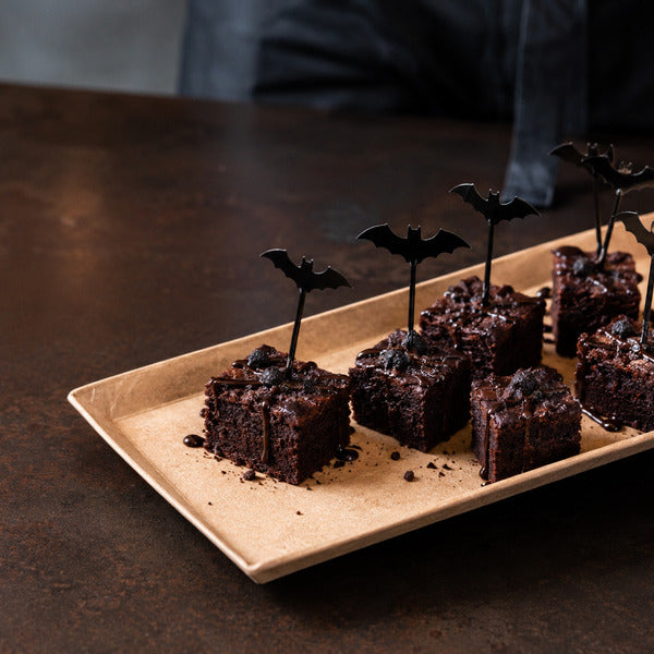 Halloween brownie bites garnished with black bamboo bat picks from Restaurantware