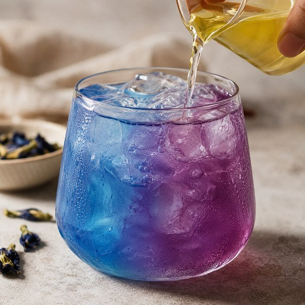 Color-changing drink made with butterfly pea flower extract, a natural food dye, shifting blue to purple