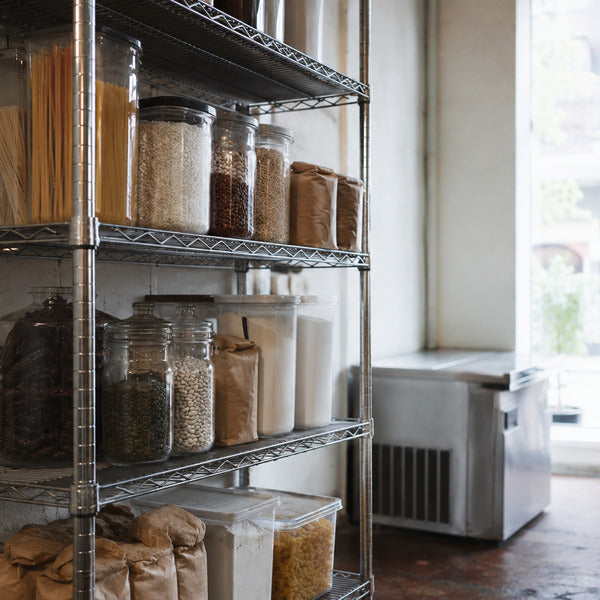 NSF-certified chrome wire shelving unit holding dry goods in a restaurant storeroom