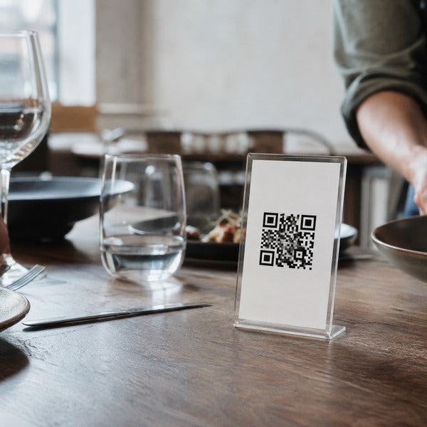 QR code menu displayed in a tabletop holder, a modern menu presentation format for contactless dining