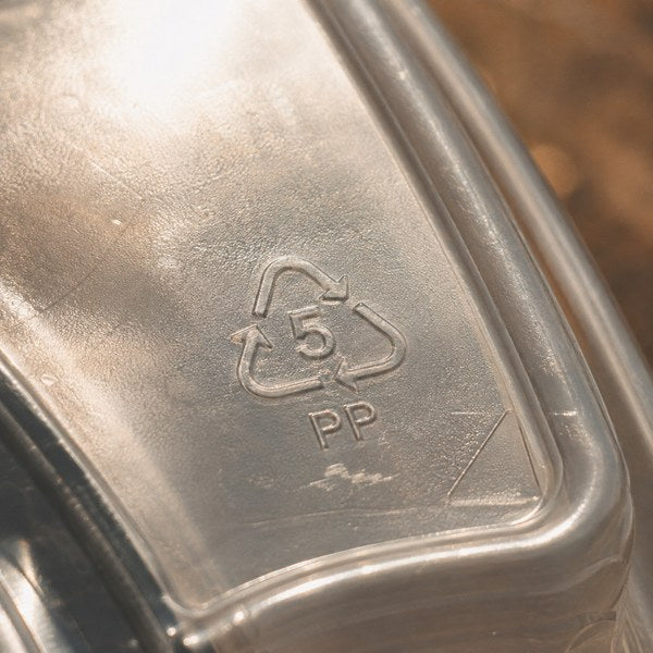 Close-up of resin identification code #5 PP stamped on a plastic recycling symbols takeout container