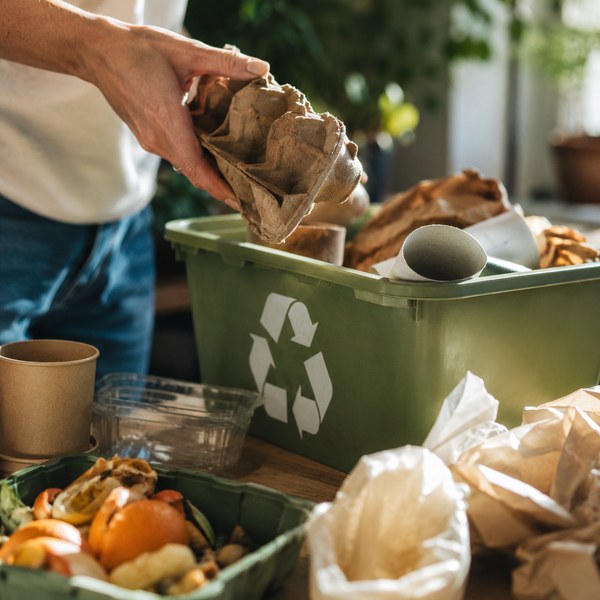 Kitchen staff sorting oil, cardboard, and plastics — the benefits of recycling extend across every stream
